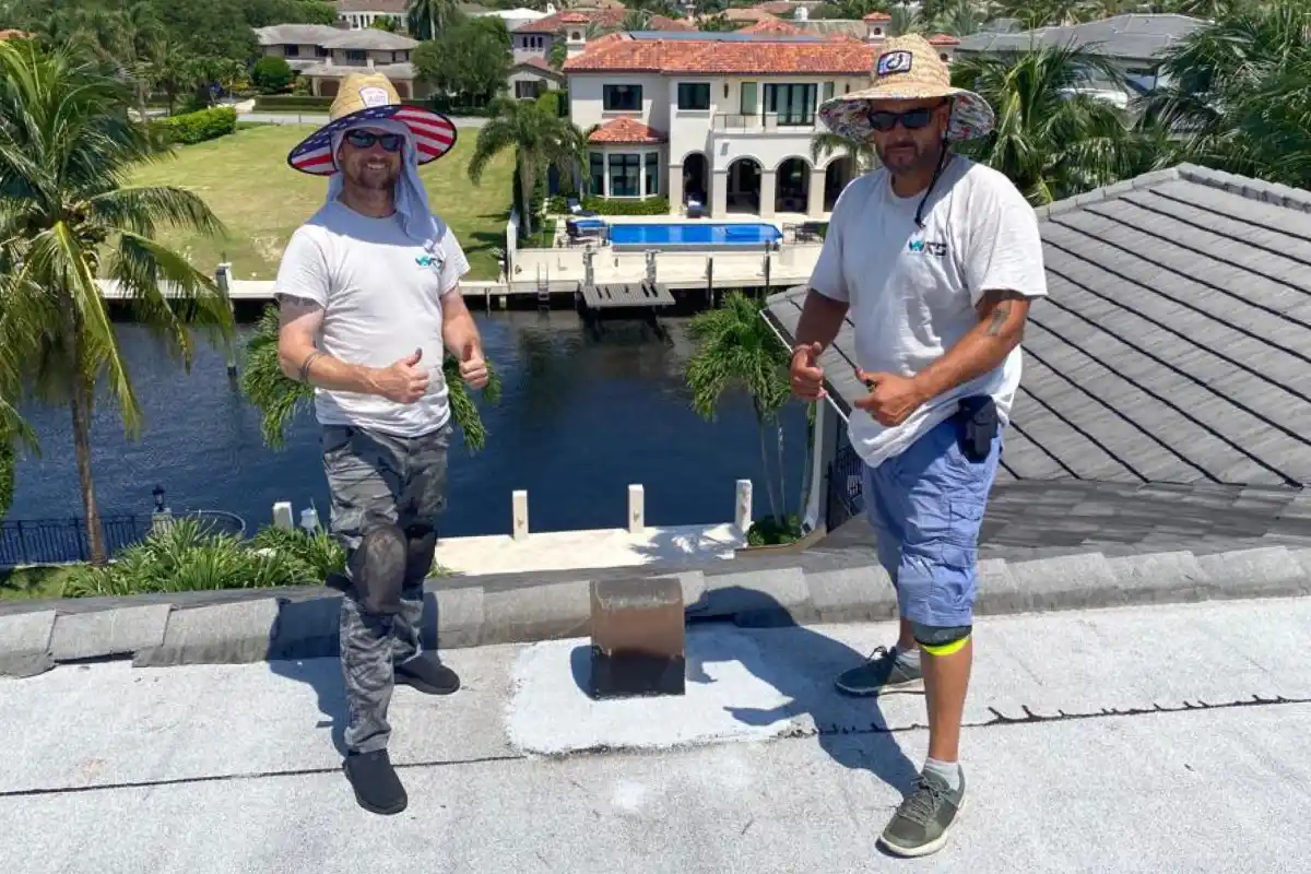 Weather Recovery Solutions Mike and Sam on-site conducting an inspection of a flat roof in South Florida.